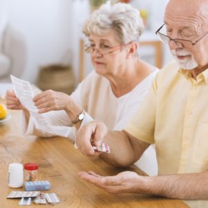 Elderly couple taking medicine.