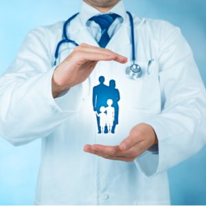 A doctor shelters a drawing of a family between his hands.