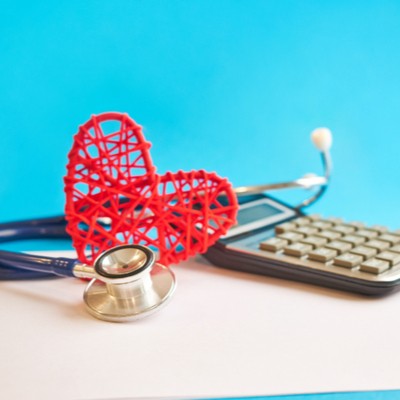 Stethoscope, calculator and a heart made out of red string