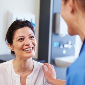 A patient smiles at a doctor.