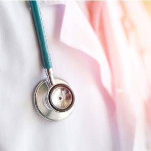 A physician wearing a white coat and stethoscope.