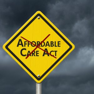 Yellow road sign reading "Affordable Care Act" with a red x over the words to indicate repealing the ACA..