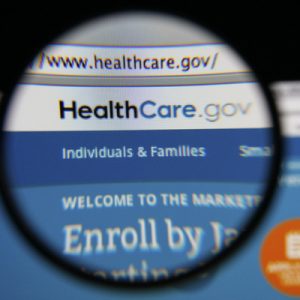 A screenshot of HealthCare.gov under a magnifying glass.