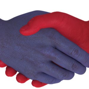A handshake between a red hand and a blue hand, indicating the bipartisanism of the Bipartisan Budget Act.