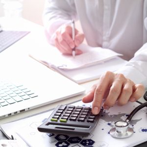 Health worker using a calculator