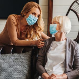 Image of two women wearing a mask