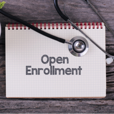 Image of a notebook with text "Open Enrollment"