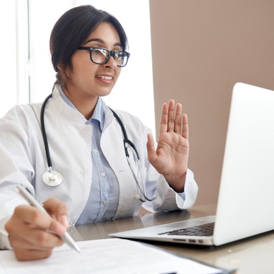 Health care provider having conversation at laptop