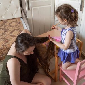 Kid brushing mom's hair