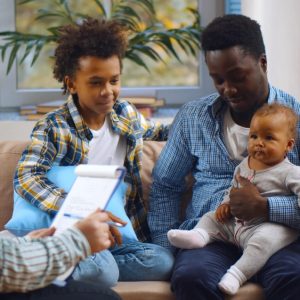 A family fills out a Medicaid form.