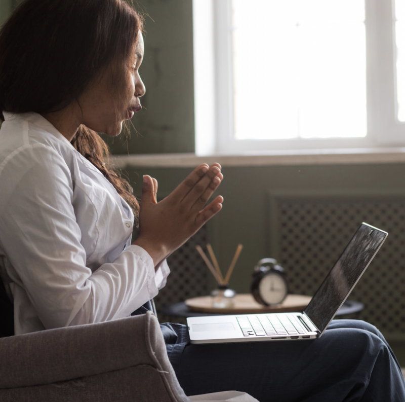 Woman speaking to laptop