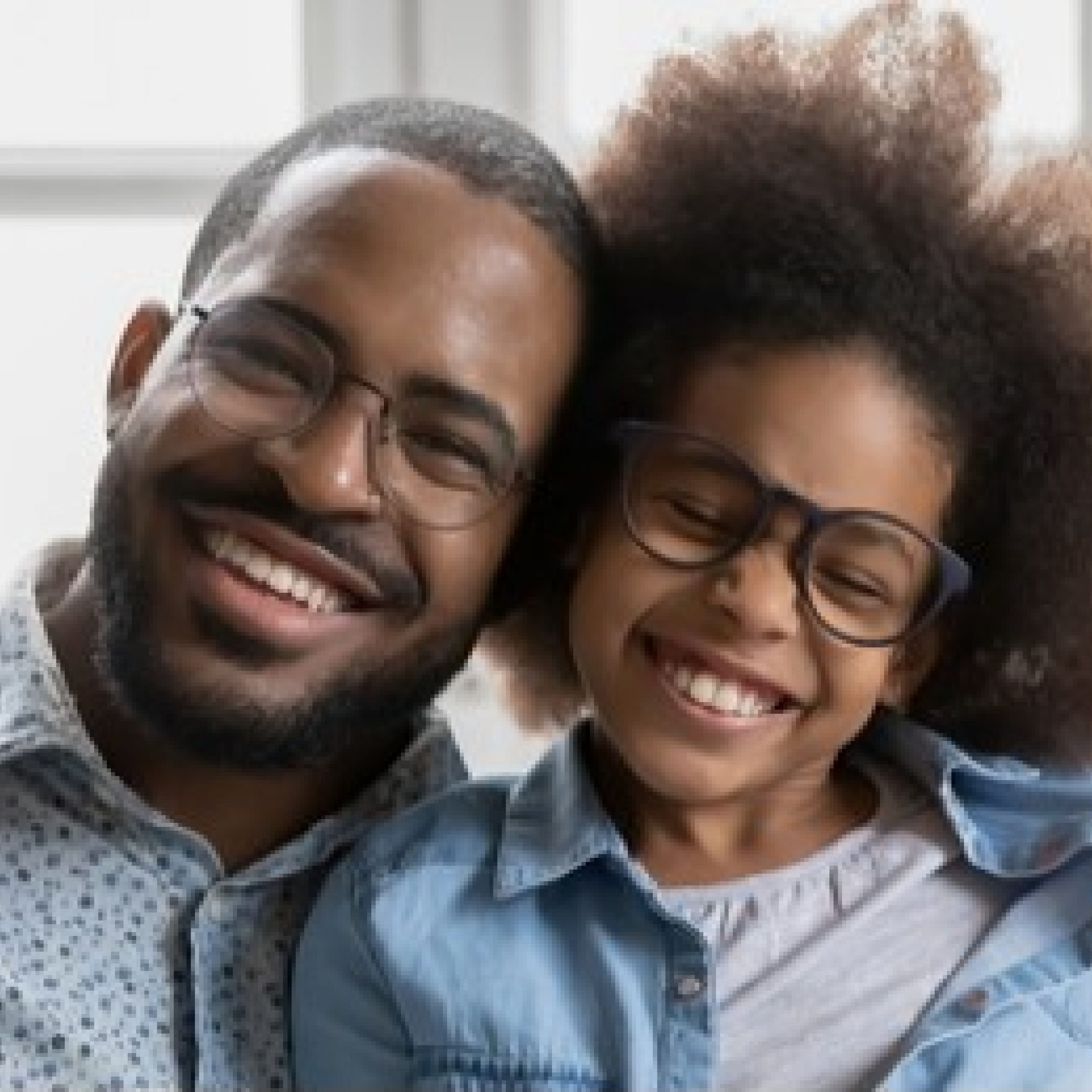 Father and daughter smiling. Both wear glasses and have beautiful smiles.