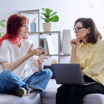 Young girl speaking to attentive therapist