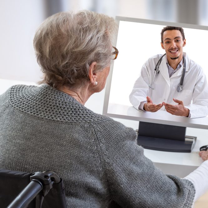 An older woman meets with a doctor via telehealth