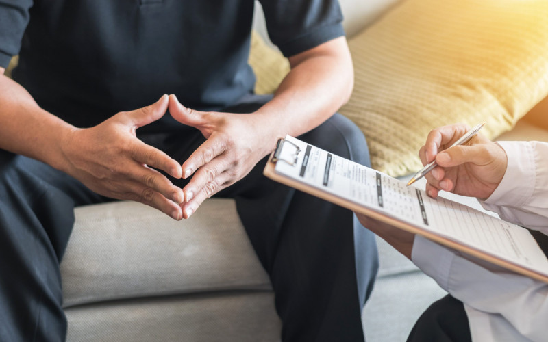 Doctor and patient reviewing patient's medical chart