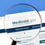 A magnifying glass hovers over the URL "Medicaid.gov"