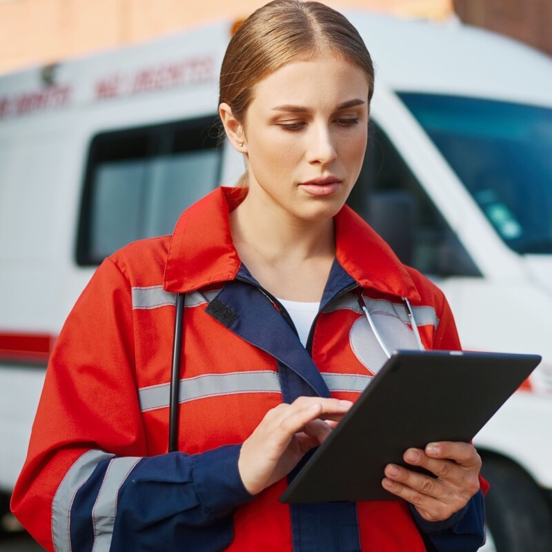 An emergency medical services staff member reviews data on her clipboard