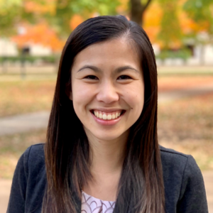 Debbie Chen in a public park smiling.