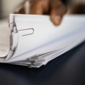 Man flips through a stack of paperwork.