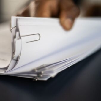 Man flips through a stack of paperwork.