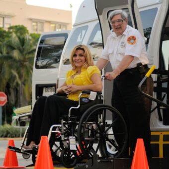 Man pushes woman in a wheelchair.
