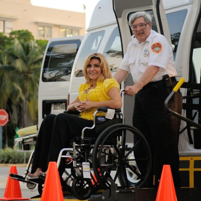 Man pushes woman in a wheelchair.